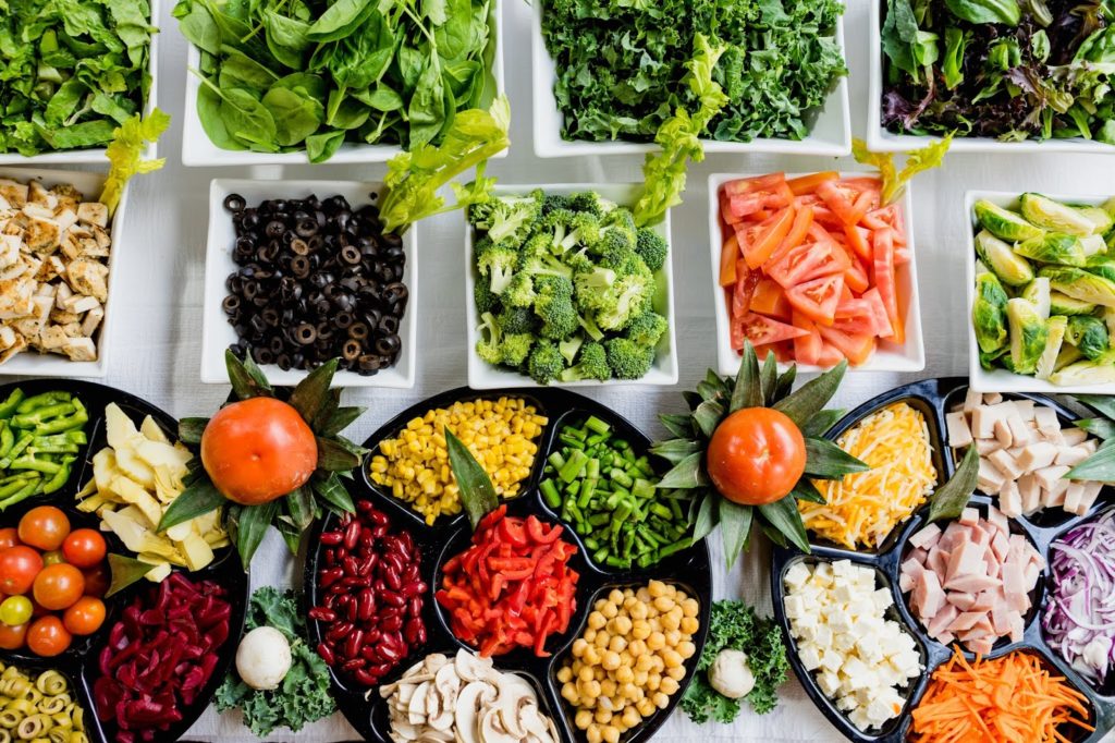 Photo de petites assiettes et plats remplis de petits morceaux de légumes de toutes les couleurs